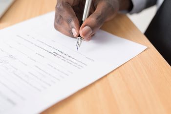 person signing a document