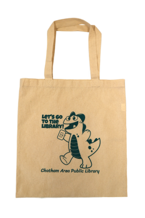 A cotton totebag with a drawing of a dinosaur on it. The text reads "Let's go to the library!"
