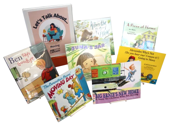 Seven children&#039;s picture books and a binder propped on easels. The binder is labeled &quot;Let&#039;s Talk About... Dementia&quot;