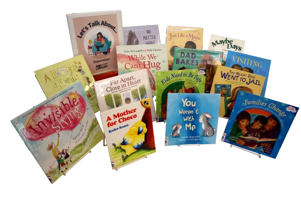 Fourteen children&#039;s picture books and a binder propped on easels. The binder is labeled &quot;Let&#039;s Talk About... Dementia&quot;