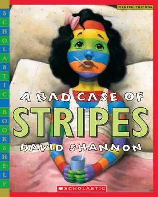 a girl lying on pillows with a thermometer in her mouth covered in bright rainbow stripes